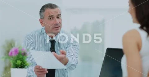 Insurance agent shows the contract to the client in the office b Stock Photos