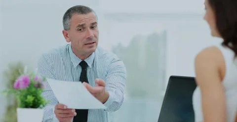 Insurance agent shows the contract to the client in the office b Stock Photos