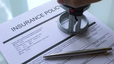 Insurance policy document approved, hand stamping seal on official paper closeup Stock-Footage 99014911