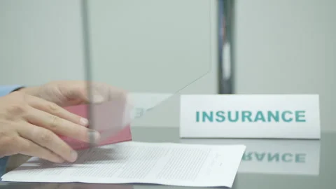 Insurer checking passport and stamping insurance agreement Stock Footage 247709751
