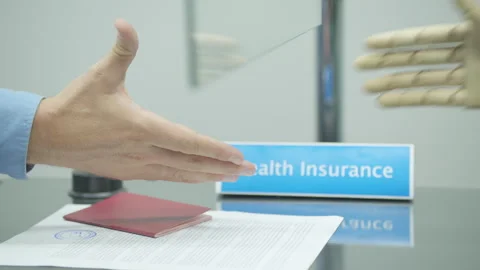 Insurer shaking hands with invalid after agreement at health insurance office Stock Footage 247709612