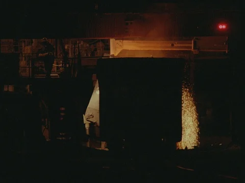 INT DAY STEEL MILL- WORKER THROWS CHEMICALS INTO CAULDRON -SPARKS ,FIRE Stock Footage 75372511