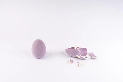 Intact and Shattered Lavender Easter Eggs: Symbolizing New Beginnings, Frag.. Stock Photos