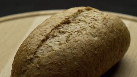 Integral bread on a wooden board Stock Footage 117343484