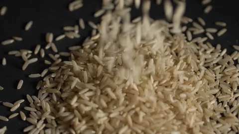 Integral rice falls on a black background Stock Footage 106707630