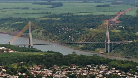 Integration Bridge with yellow suspension cables and dual towers crossing the Stock Footage 327645283
