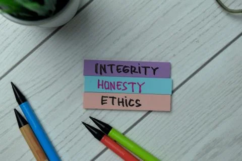 Integrity, Honest, Ethics write on sticky notes isolated on office desk. Stock Photos