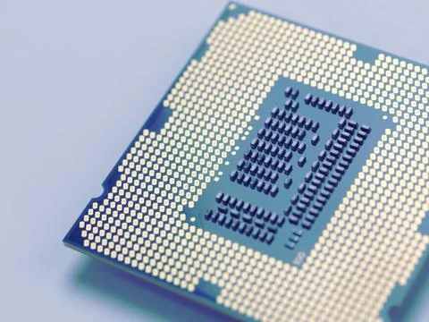 Intel i7 processor gold contacts CPU socket circuit isolated on blue background Stock Photos