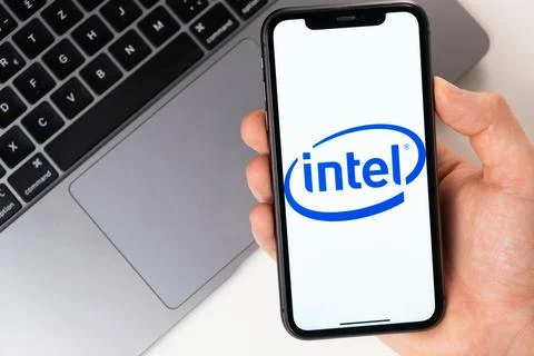 Intel mobile application on the smartphone screen. A mobile phone in a man hand Stock Photos
