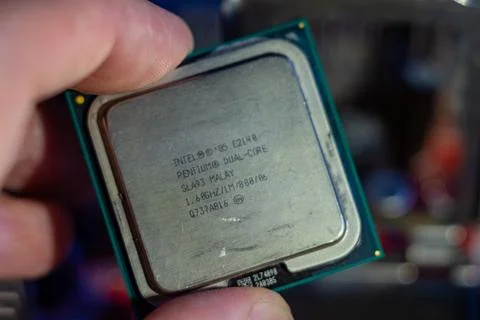 Intel pentium dual core processor held by human hand for computer hardware Stock Photos