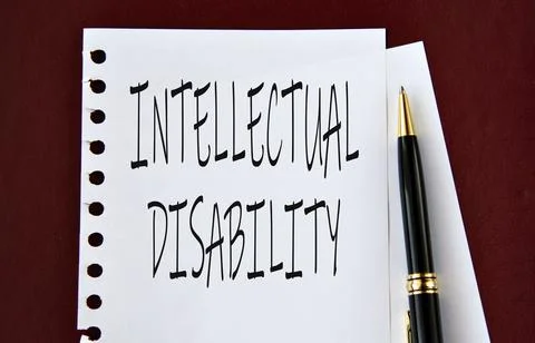 INTELLECTUAL DISABILITY - words on a white sheet on a brown background with.. Stock Photos