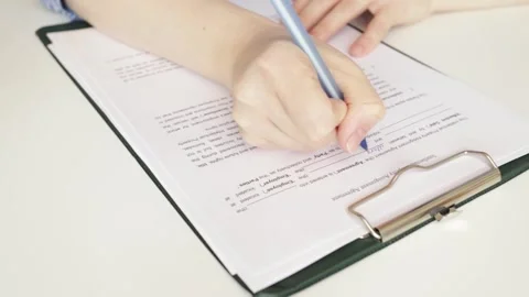 Intellectual property assignment agreement, hand fills out a document, lega.. Video stock 274474624