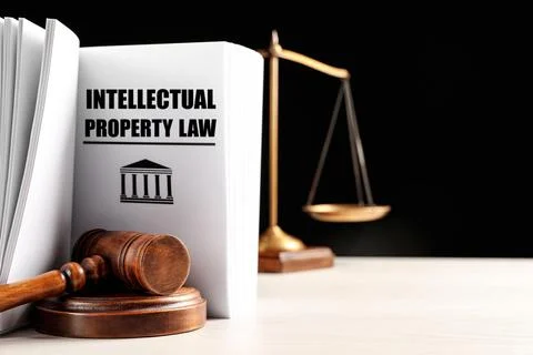 Intellectual Property law book, judge's gavel and scales of justice on white  Stock Photos