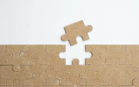 Intellectual puzzles. The puzzle empty. The hand puts together puzzle piece.. Stock Photos