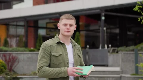 The Intellectual A Young Guy Sitting with Book in the City Stock Footage 323925257