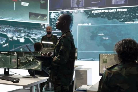 Intelligence analyst comparing satellite surveillance data Stock Photos
