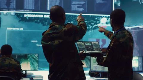Intelligence analysts supervising and coordinating the big data analysis Stock Photos