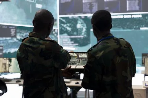 Intelligence analysts supervising data visualization on big screen Foto stock