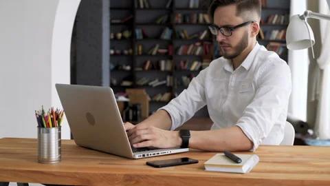 Intelligence leader in glasses alone work by personal computer in trendy workpla Video stock 199491454