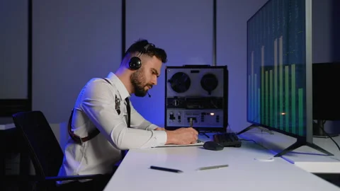 Intelligence officer analyzing intercepted audio recordings Stock Footage 305007720