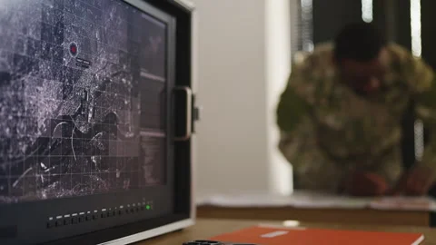 Intelligence officer planning ground offensive strategy using topographic maps Stock Footage 333308058