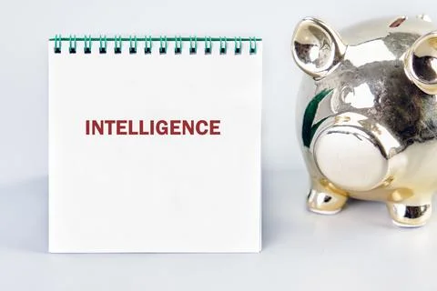 INTELLIGENCE word written in a notebook on a light background. Translation Stock Photos