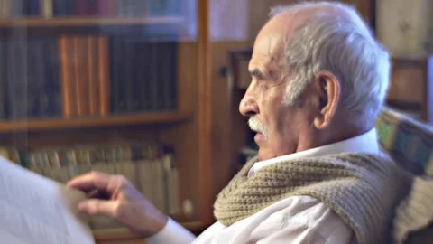 Intelligent Aging Man Estimates Book Discovering His Opinion Spines of Books Stock Footage 72230217