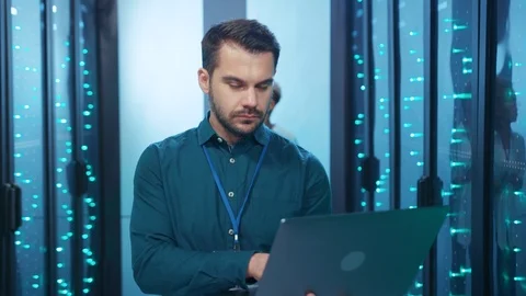 Intelligent attractive IT admin with laptop computer smiling at camera in high Stock Footage 119841516