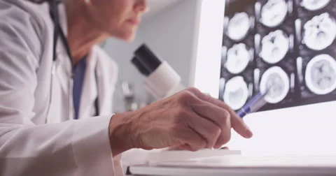 Intelligent female radiologist analyzing with microscope Video stock 58219073