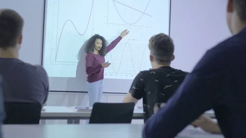 Intelligent female student presenting a project in the classroom Stock Footage 74615405