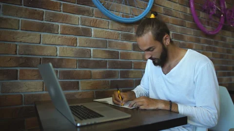 Intelligent male freelancer work on notebook Stock Footage 67100173
