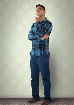 Intelligent man standing thinking against wall in room Foto stock