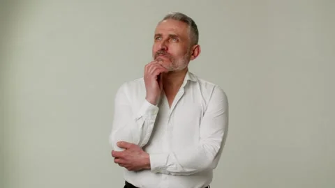 An intelligent middle aged man in deep thoughts decides about a radical change Stock Footage 252880501