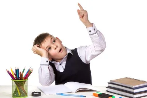 Intelligent pupil finally found the solution for exercise on the white Stock Photos