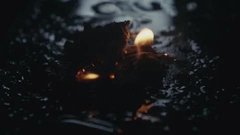 Intense and Flickering Flames Dancing Gracefully on a Dark, Mysterious Surface Stock Footage 309544020