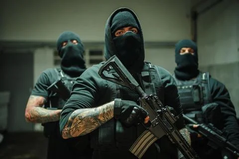 Intense armed tactical team preparing for a covert operation with their powerful Stock Photos