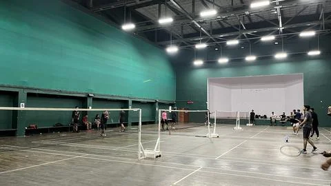 Intense Badminton Match in Progress on a Vibrant Indoor Court with Players Stock Photos