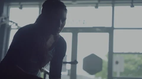 Intense battle rope workout session featuring woman at local gym Stock Footage 312707895