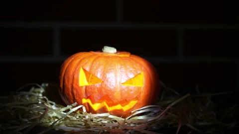 Intense beam of light highlights on halloween pumpkin Video stock 219347330