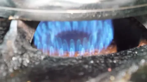 Intense Blue Gas Flame Igniting on Kitchen Stove Burner for Cooking Stock Footage 338212398