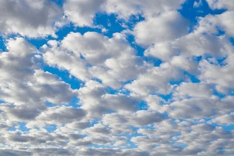 Intense blue sky full of white clouds Stock Photos