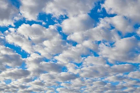Intense blue sky full of white clouds Stock Photos