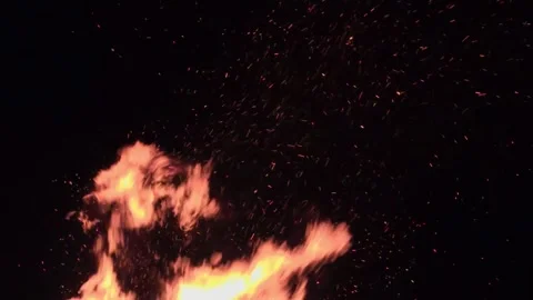 Intense Bonfire Flames and Flying Embers Against Night Sky – Dramatic Stock Stock Footage 339018340