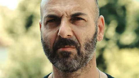 Intense close-up of bald man looking serious and menacing Video stock 278365285