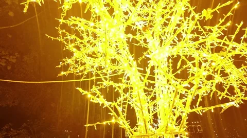 Intense Close-Up of a Man-Made Tree Densely Covered in Bright Yellow LED Lights Stock Footage 322850345