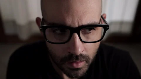Intense close-up of a young man showing symptoms of anxiety Stock Footage 306846546