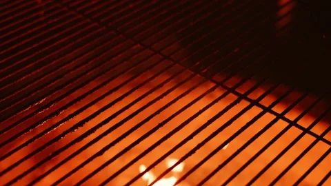 This is an Intense CloseUp of Burning Grill Grates Accompanied by Flames Dancing Stock Footage 318952693