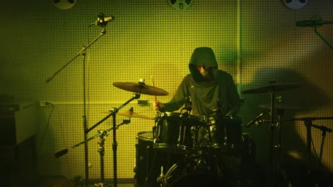 Intense Drumming in a Vibrant Green-Lit Studio Video stock 312347403