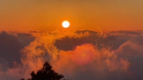 Intense Fiery Sun Disc Setting Above Illuminated Cloudscape Stock Footage 320604400