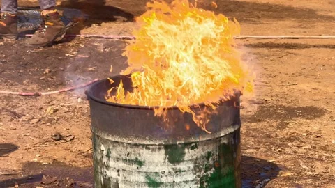 Intense fire blazing in metal barrel outdoors. Stock Footage 341925644